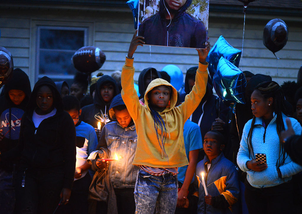 Dajion Harris' sister DenayJah Harris holds up a sign with a photo of him during a vigil in Columbia on Thursday (copy)